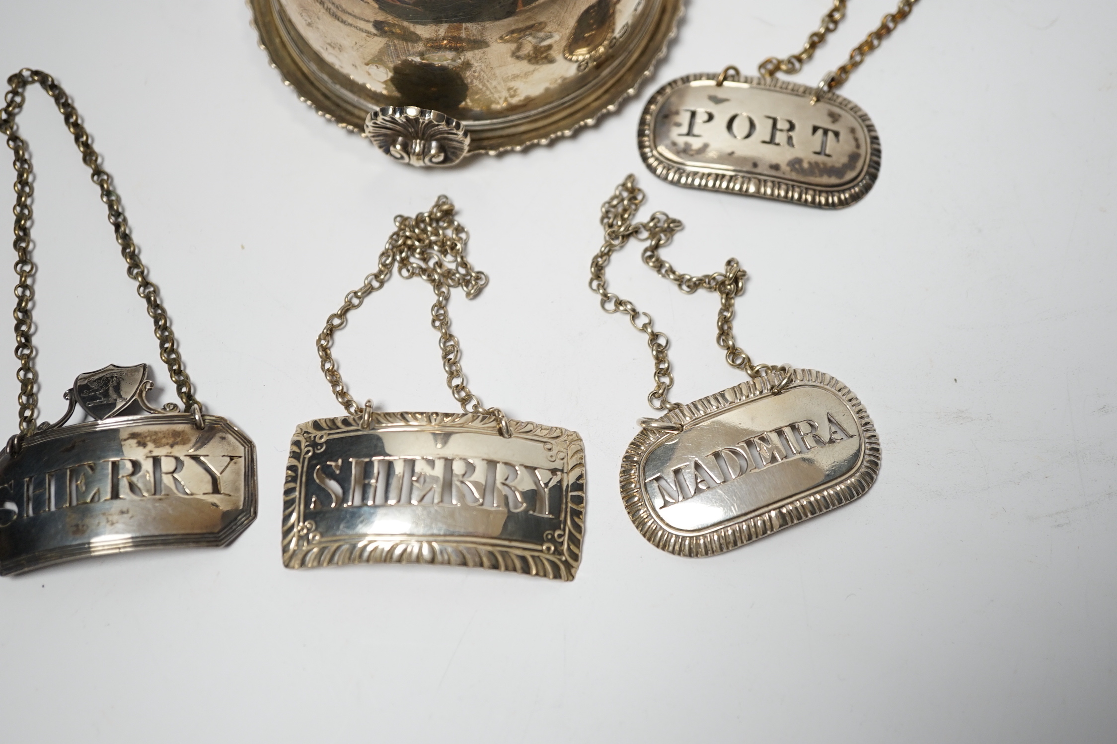 A George IV silver wine funnel, London, 1825, 12.9cm and four George III silver wine labels including pair by Phipps & Robinson, London, 1808/9.